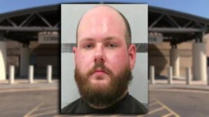 Mugshot of Eric Plemmons, a 26-year-old Lubbock man arrested for possession and promotion of child sexual abuse material, shown in front of the Lubbock County Detention Center.
