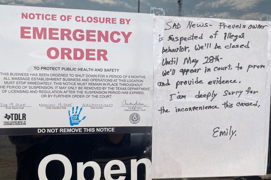 Emergency closure notice from the Texas Department of Licensing and Regulation posted on a Lubbock massage parlor, citing a six-month shutdown due to public health and safety concerns amid a human trafficking investigation; handwritten sign beside it explains the closure is linked to suspected illegal behavior and announces a court appearance scheduled for May 28.