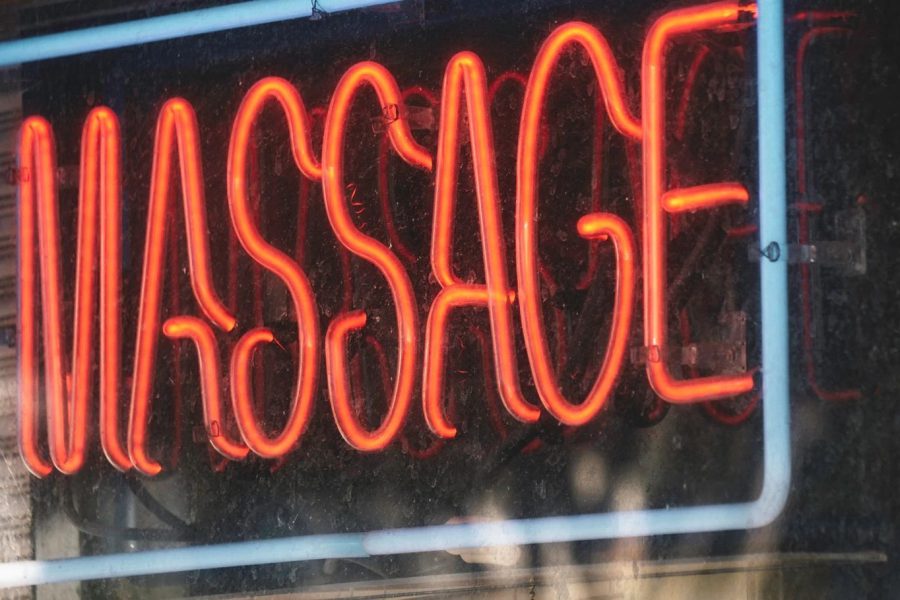 Neon massage sign in window, representing a Lubbock massage parlor recently shut down and permanently banned by TDLR due to human trafficking investigation.
