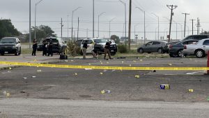 Police investigate officer-involved shooting scene on Parkway Drive in Lubbock, Texas, marked by evidence tags and crime scene tape following early morning gunfire on July 5, 2025.