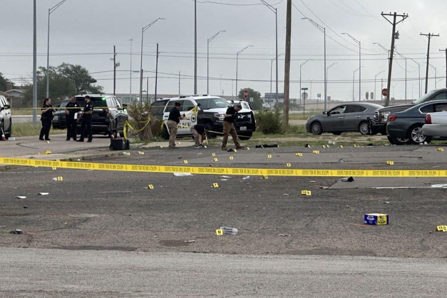 Police investigate officer-involved shooting scene on Parkway Drive in Lubbock, Texas, marked by evidence tags and crime scene tape following early morning gunfire on July 5, 2025.