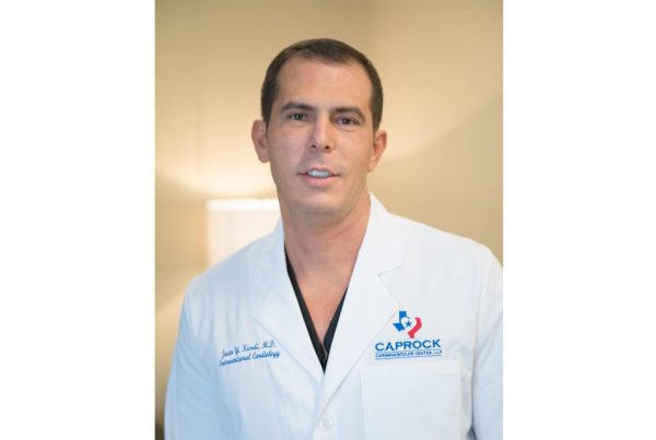 Dr. Juan Kurdi wearing a white lab coat with Caprock Cardiovascular Center logo.