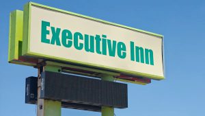 Executive Inn sign at 4401 Avenue Q in Lubbock, Texas, hotel under police scrutiny for shootings and ongoing criminal activity.