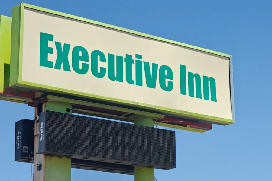 Executive Inn sign at 4401 Avenue Q in Lubbock, Texas, hotel under police scrutiny for shootings and ongoing criminal activity.