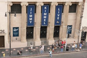 Exterior of the Jimmy Kimmel Live studio in Hollywood with show banners and crowds gathered on the Walk of Fame.