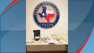 Evidence displayed at the Texas Anti-Gang Center in Lubbock, including seized drugs, cash, and paraphernalia, following multiple arrests during a September 2025 search warrant.