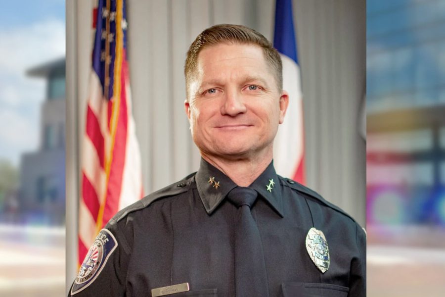Seth Herman, Midland Police Chief and finalist for Lubbock’s next police chief, wearing his uniform and standing in front of U.S. and Texas flags.