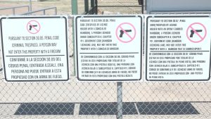 Signs at the South Plains Fair in Lubbock, Texas, stating firearms are not allowed, including concealed and open carry handguns under Texas Penal Code Sections 30.05, 30.06, and 30.07.