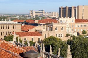 View of Texas Tech University campus in Lubbock, showing red-tiled rooftops and academic buildings on a clear day.