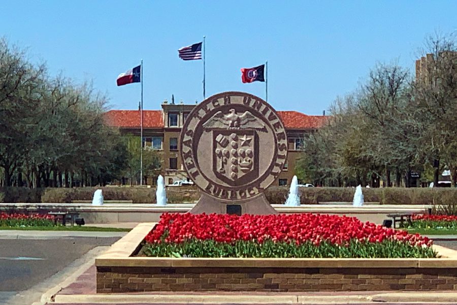 Texas Tech University seal with red flowers, fountains, and campus buildings in the background.