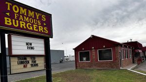 Exterior of Tommy’s Famous Burgers in Lubbock with sign thanking customers for 47 years of business before closing.