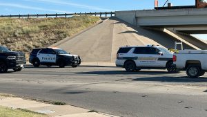 Lubbock County Sheriff and Lubbock Police vehicles parked near the I-27 and 34th Street overpass following a low-speed collision involving a deputy and a bicyclist.