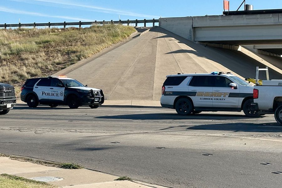 Lubbock County Sheriff and Lubbock Police vehicles parked near the I-27 and 34th Street overpass following a low-speed collision involving a deputy and a bicyclist.