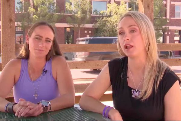 Two South Plains women sit at an outdoor table during a TV interview, discussing how the justice system failed to protect them from domestic violence.