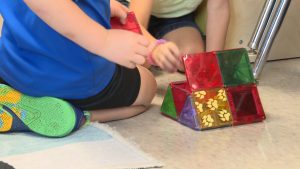 Children in a Lubbock daycare classroom playing with colorful magnetic building blocks, highlighting child care shortages across the South Plains.
