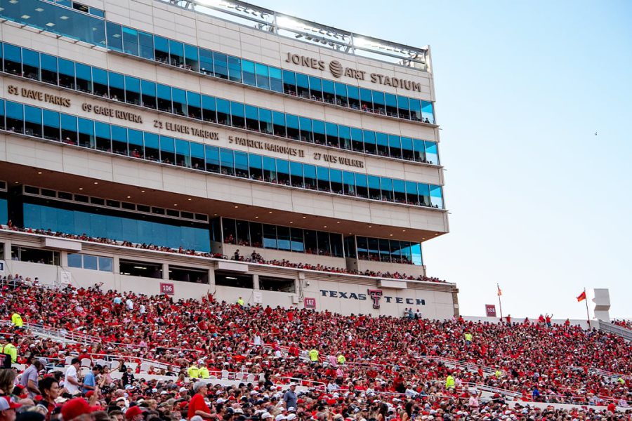 Crowd of Texas Tech fans in red filling the stands at Jones AT&T Stadium in Lubbock, Texas, during a home football game.