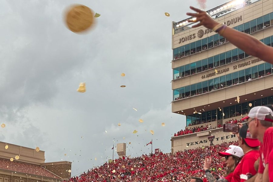 Tortillas flying through the air at Jones AT&T Stadium as Texas Tech fans celebrate kickoff during a home football game.