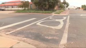 Faded Buddy Holly glasses painted on a Lubbock crosswalk slated for removal under Governor Abbott’s new directive.