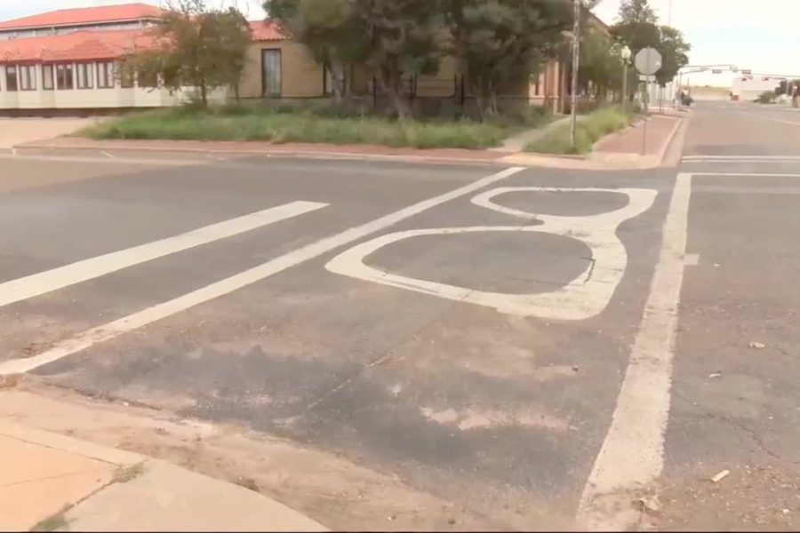 Faded Buddy Holly glasses painted on a Lubbock crosswalk slated for removal under Governor Abbott’s new directive.