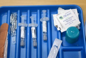 Syringes, alcohol prep pads, and medical supplies arranged in a tray during a vaccination drive at the City of Lubbock Health Department.