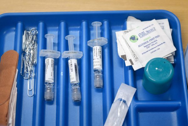 Syringes, alcohol prep pads, and medical supplies arranged in a tray during a vaccination drive at the City of Lubbock Health Department.