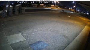 Surveillance camera image showing a white car speeding down 82nd Street in south Lubbock moments before a hit-and-run on November 1, 2025.