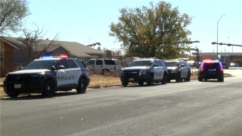 Lubbock police vehicles with flashing lights line North Zenith Avenue near the scene of a shooting that left one man seriously injured on November 11, 2025.