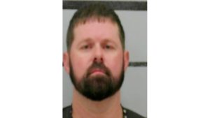 Mugshot of Matthew Price arrested in Lubbock County, shown against a height-strip background.