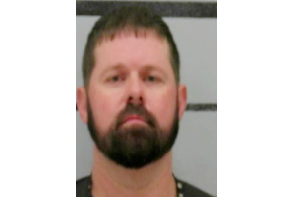 Mugshot of Matthew Price arrested in Lubbock County, shown against a height-strip background.