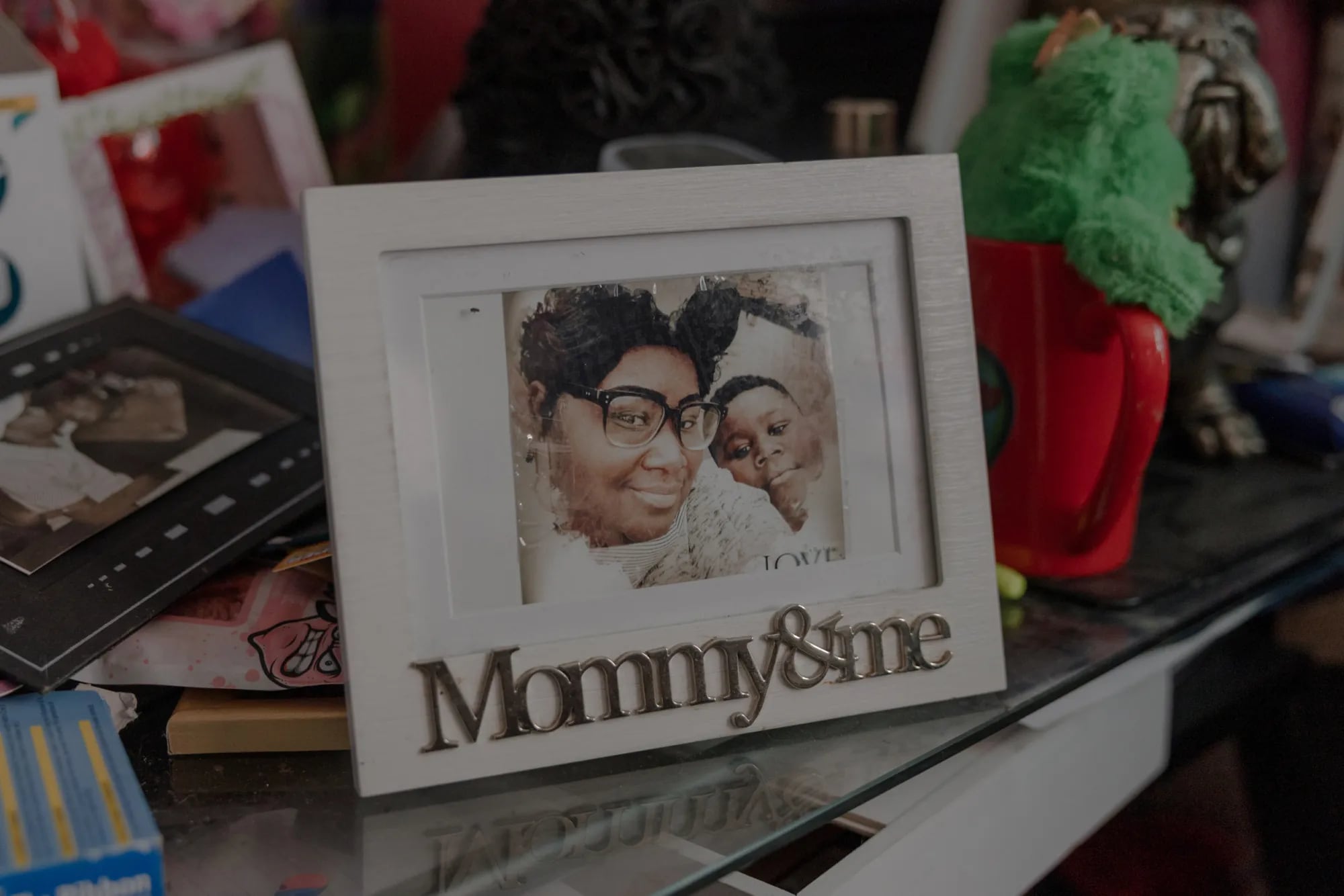 A framed “Mommy & Me” photo of a mother and her young son displayed among personal keepsakes.