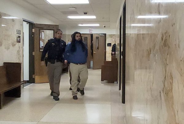 Timothy Gonzalez escorted by a law enforcement officer through the Lubbock County Courthouse hallway during his sentencing for a deadly 2021 drunk driving crash.