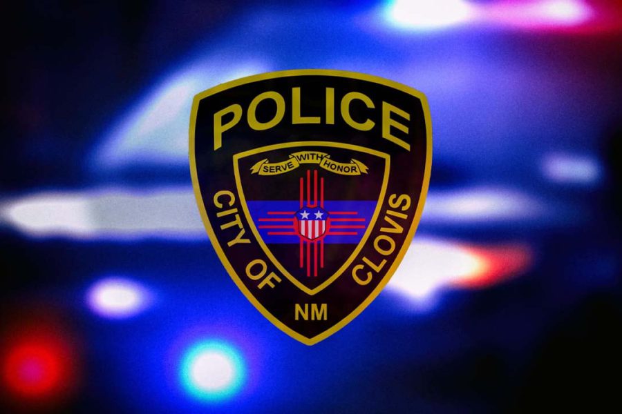 Clovis Police Department badge over blurred red and blue emergency lights in Clovis, New Mexico.