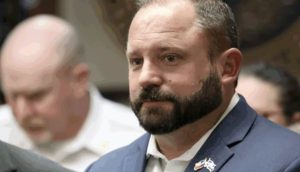 Precinct 2 County Commissioner Jason Corley looking serious during a Lubbock commissioners meeting amid controversy over an early congressional campaign announcement.