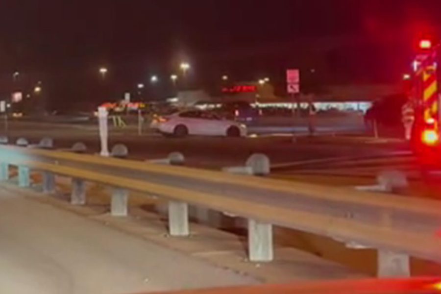 Nighttime crash scene on Spur 327 at the West Loop frontage road in Lubbock with emergency vehicles responding after a three-vehicle collision.