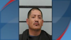 Mugshot of Lorenzo Robles, arrested in Lubbock on assault and drug charges, shown against a height chart background.