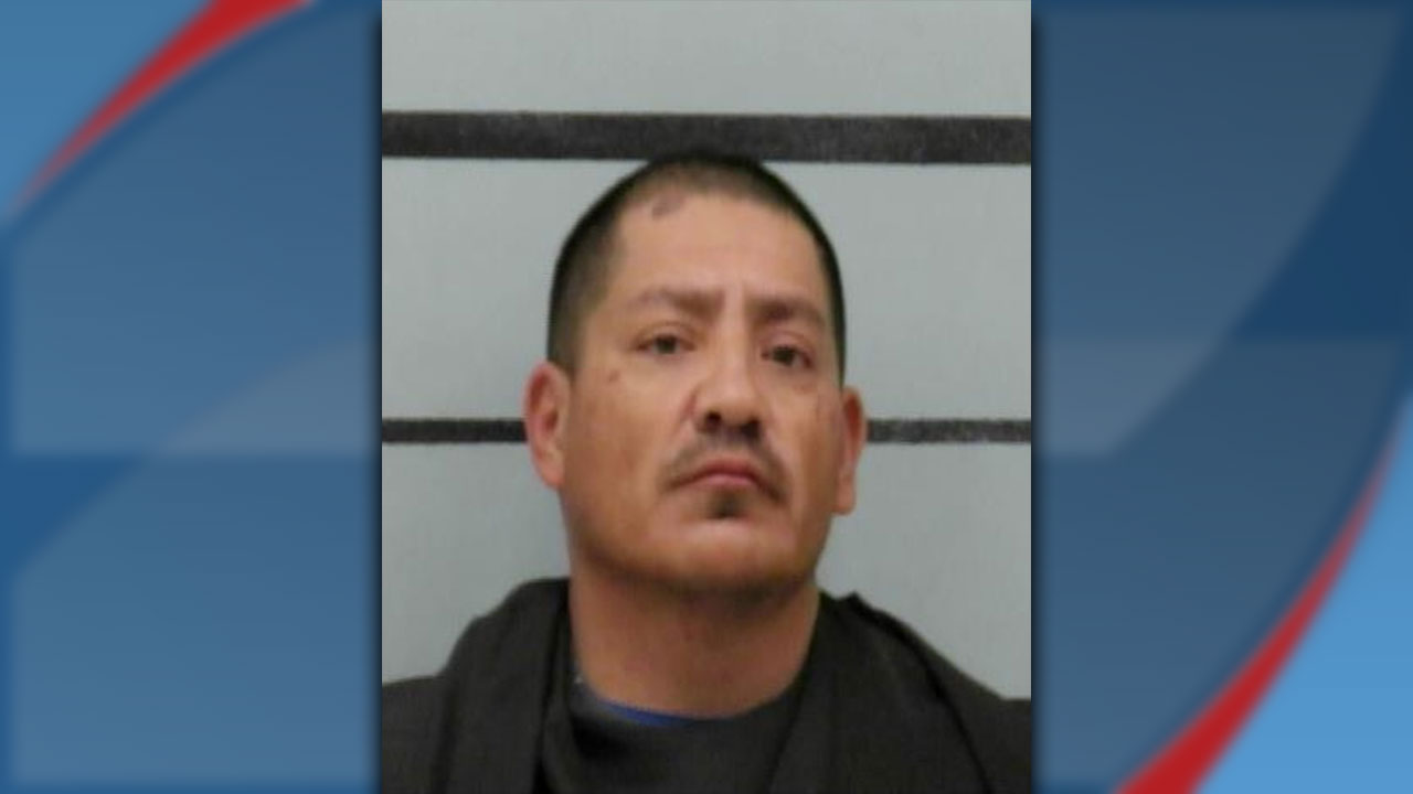 Mugshot of Lorenzo Robles, arrested in Lubbock on assault and drug charges, shown against a height chart background.