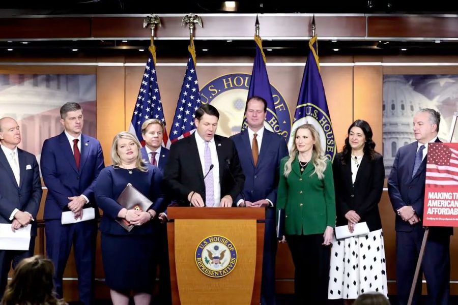 Members of Congress stand at a U.S. House podium during a press conference promoting an affordability-focused economic agenda, with American flags and a sign reading "Making the American Dream Affordable Again" in the background..