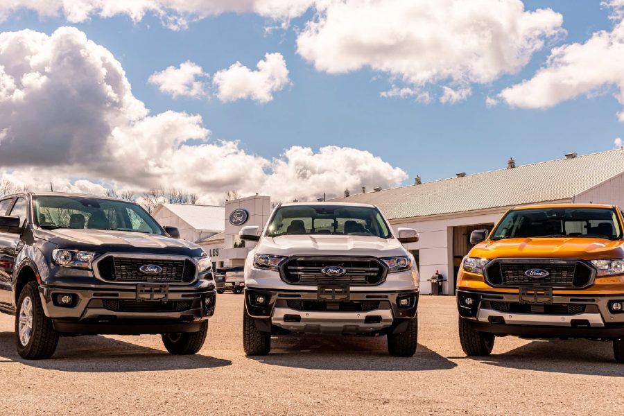 Three Ford F-150 pickup trucks lined up at a Lubbock dealership, illustrating the city’s overwhelming love for full-size trucks.