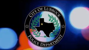 City of Lubbock Police Department seal displayed over blurred red and blue emergency lights.