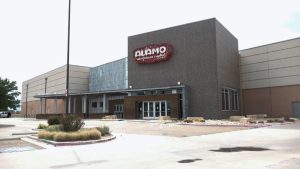 The exterior of the Alamo Drafthouse Cinema in Lubbock, Texas, showing its brick facade and logo above the entrance.
