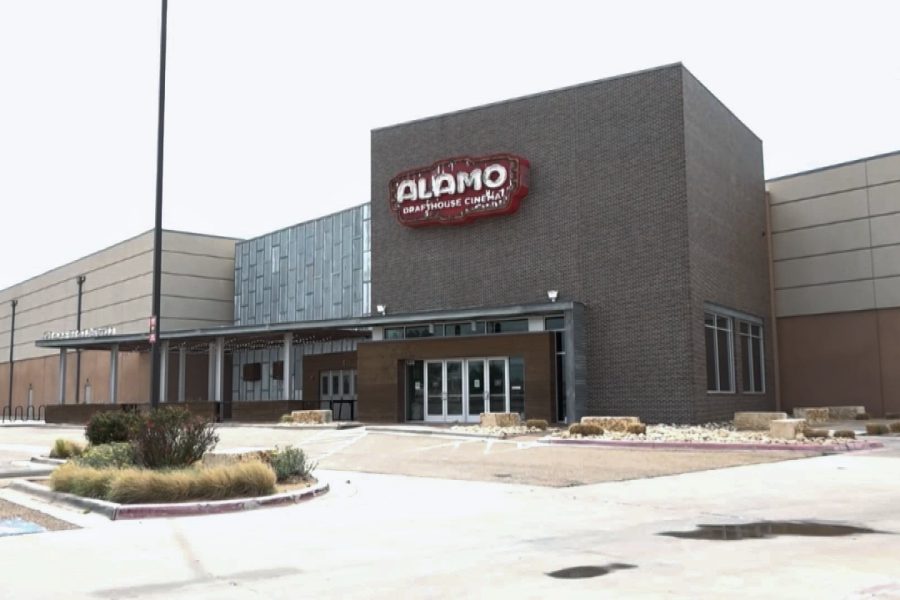 The exterior of the Alamo Drafthouse Cinema in Lubbock, Texas, showing its brick facade and logo above the entrance.
