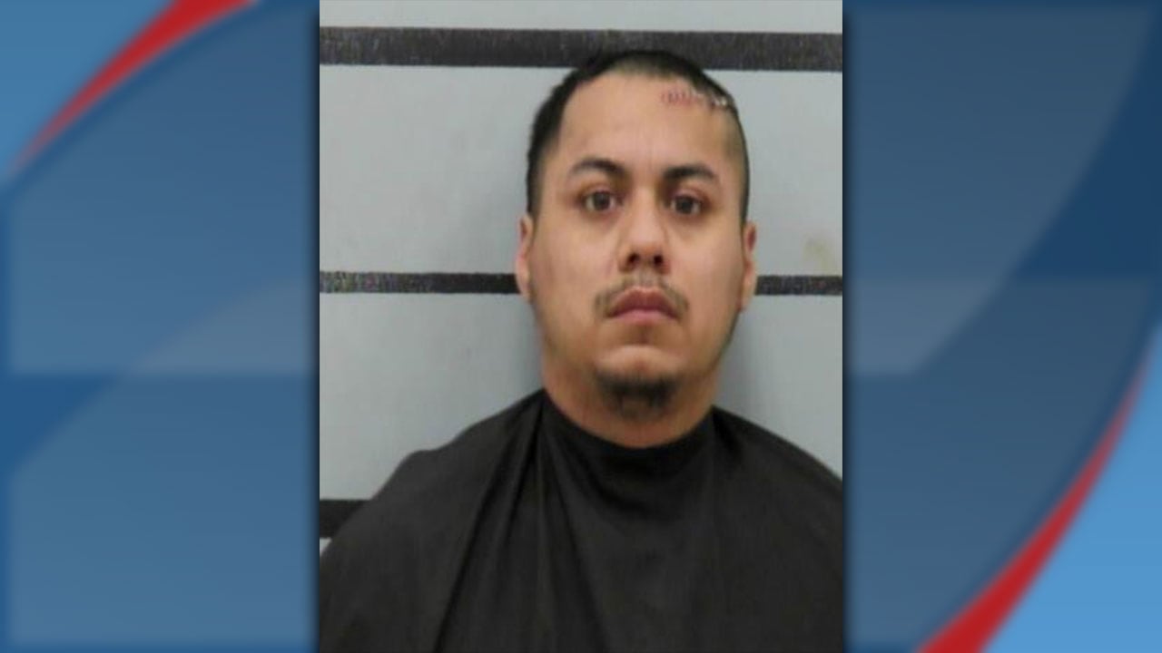 A mugshot of Jeremiah Guerrero, 27, who faces a Deadly Conduct charge in Lubbock. He is shown from the chest up against a gray background with horizontal black lines, with visible staples or stitches on the left side of his forehead.