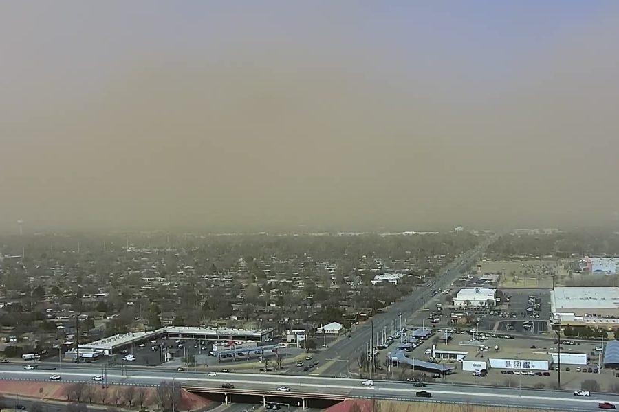 An aerial view of the South Lubbock skyline during a severe dust storm on February 17, 2026, showing a thick, brown layer of blowing dust obscuring the horizon and reducing visibility to approximately one mile.
