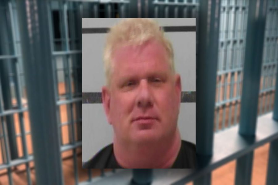 A mugshot of Texas Tech University marketing professor Daniel Taylor, looking remarkably like a man who just realized his "Pink Flamingo" supply chain didn't include a contingency plan for the DEA.