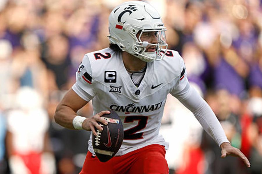 Texas Tech quarterback transfer Brenden Sorsby in mid-play while wearing his former University of Cincinnati uniform, representing the athlete currently facing a $1 million federal lawsuit for an alleged NIL contract breach.