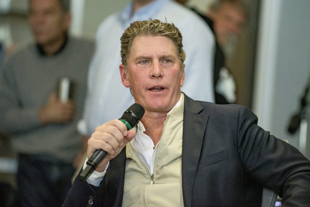 Bo French, Republican candidate for Texas Railroad Commissioner, clutching a microphone while looking like he's mid-sentence explaining how deporting 100 million people will definitely help regulate gas pipelines.