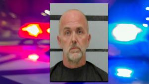 Mugshot of Brandon Box against a grey background with black horizontal height lines.