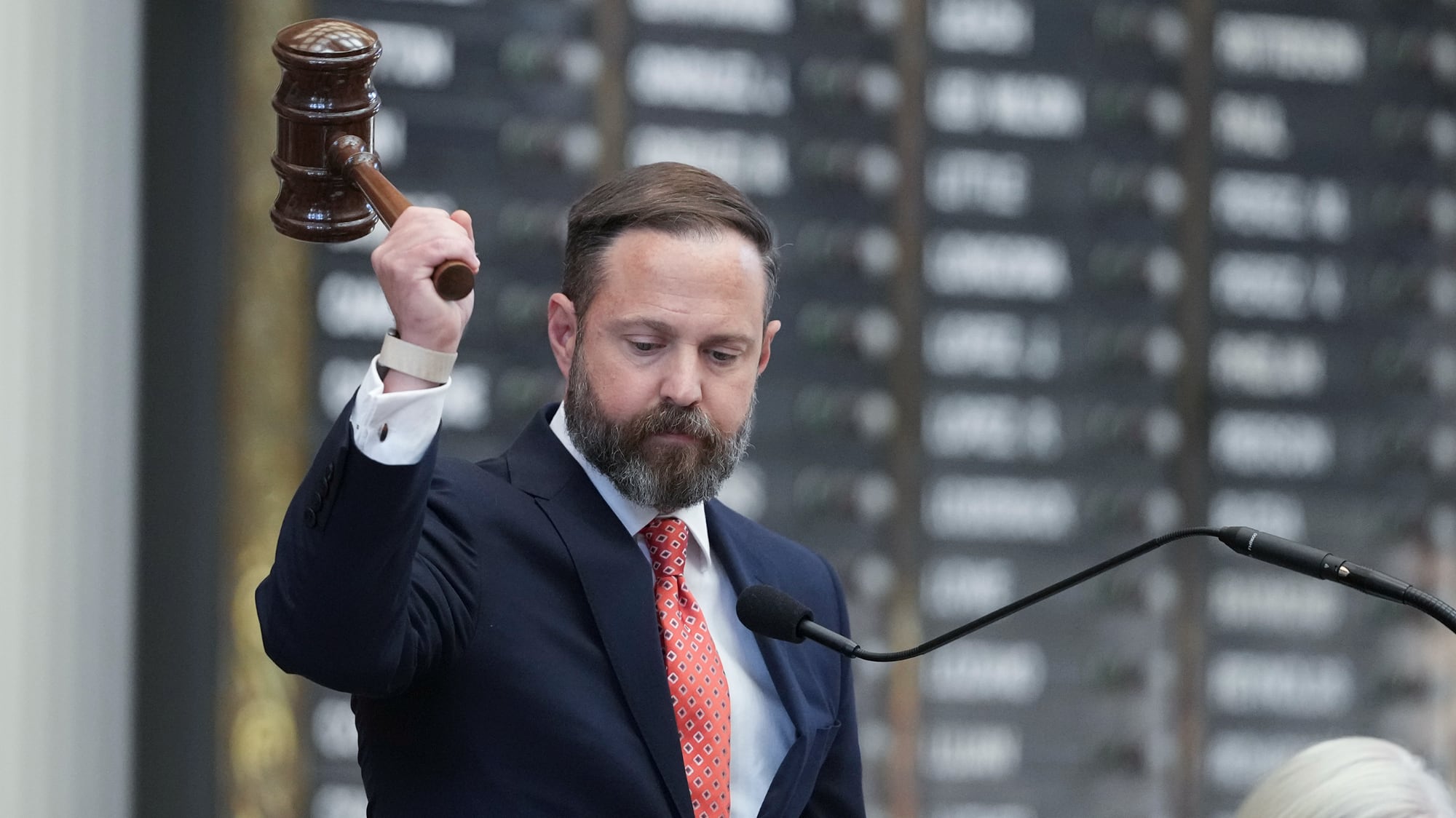 A deeply focused Dustin Burrows raises a giant wooden gavel high in the air, looking like a man who is about to heroically strike down a fly or perhaps just finalize a plan to turn eastern New Mexico into Lubbock’s newest, dustiest suburb.