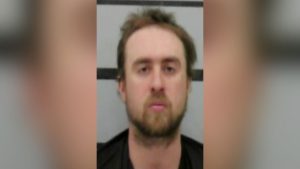 Mugshot of Daniel King, 28, looking like the human personification of why we tell you to stay off 98th Street after midnight; he sports messy hair and the blank stare of a man who just realized ‘render aid’ isn't just a polite suggestion.