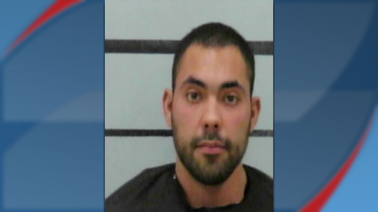 A mugshot of 29-year-old Nicholas Alonzo, a former Frenship ISD fifth-grade teacher, appearing with short dark hair and a beard against a gray and white barred background.